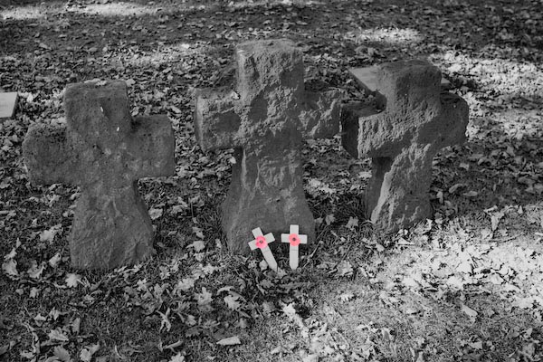 Langemark German WW1 Cemetery Symbolic markers with poppy crosses laid by British Schoolchidren