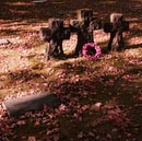 Langemark German WW1 Cemetery Symbolic markers with poppy wreath laid by British Schoolchidren